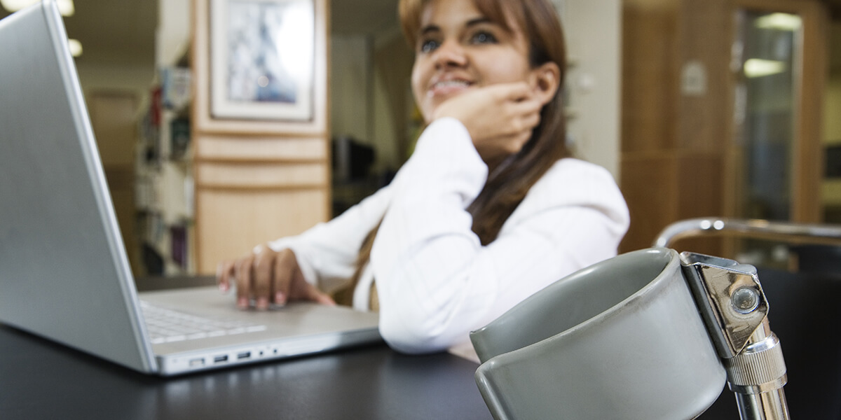 Young disabled women working at her computer